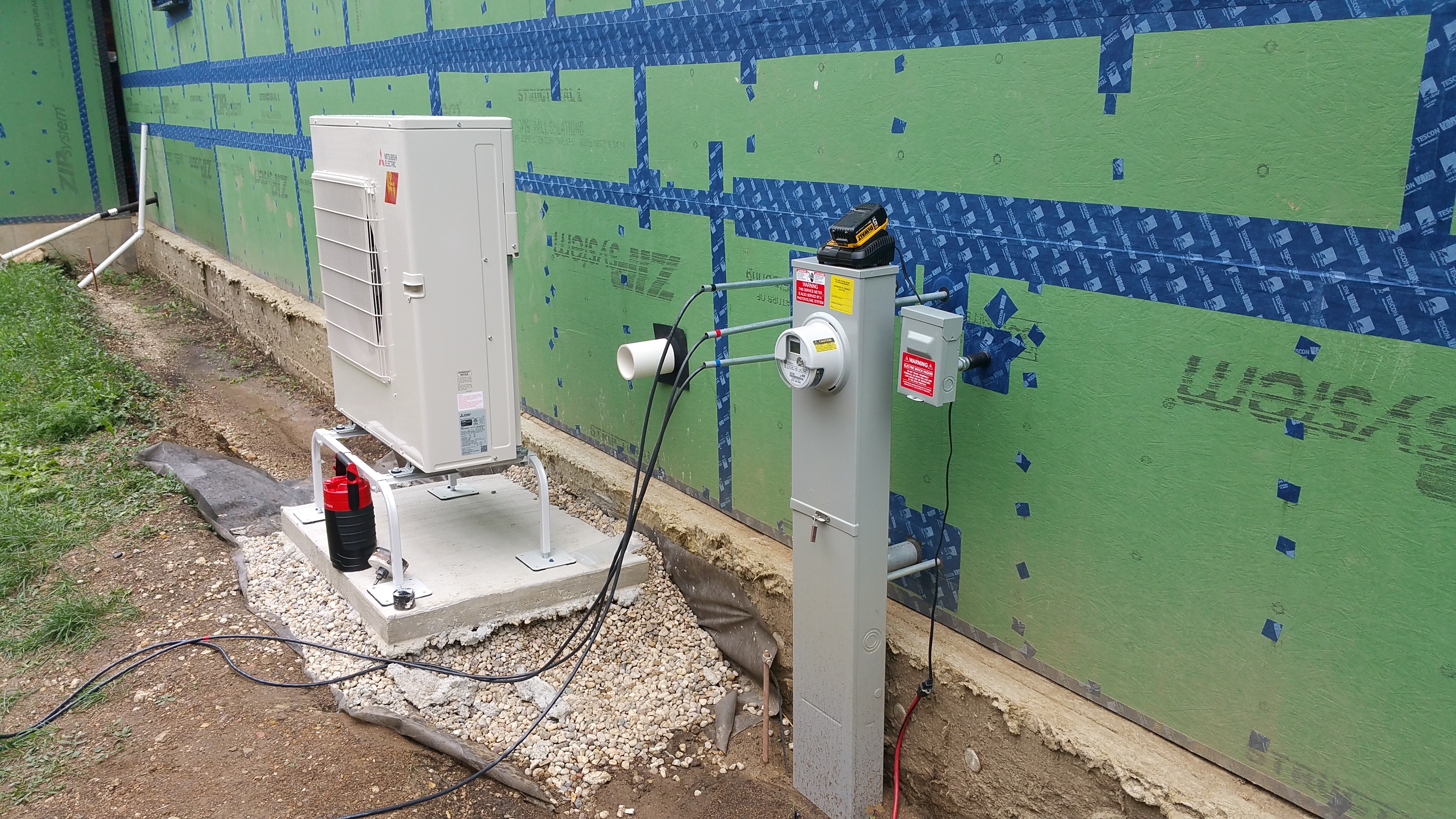 heat pump being installed on pad