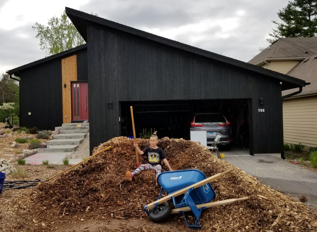 mulch and wheel barrow in driveway
